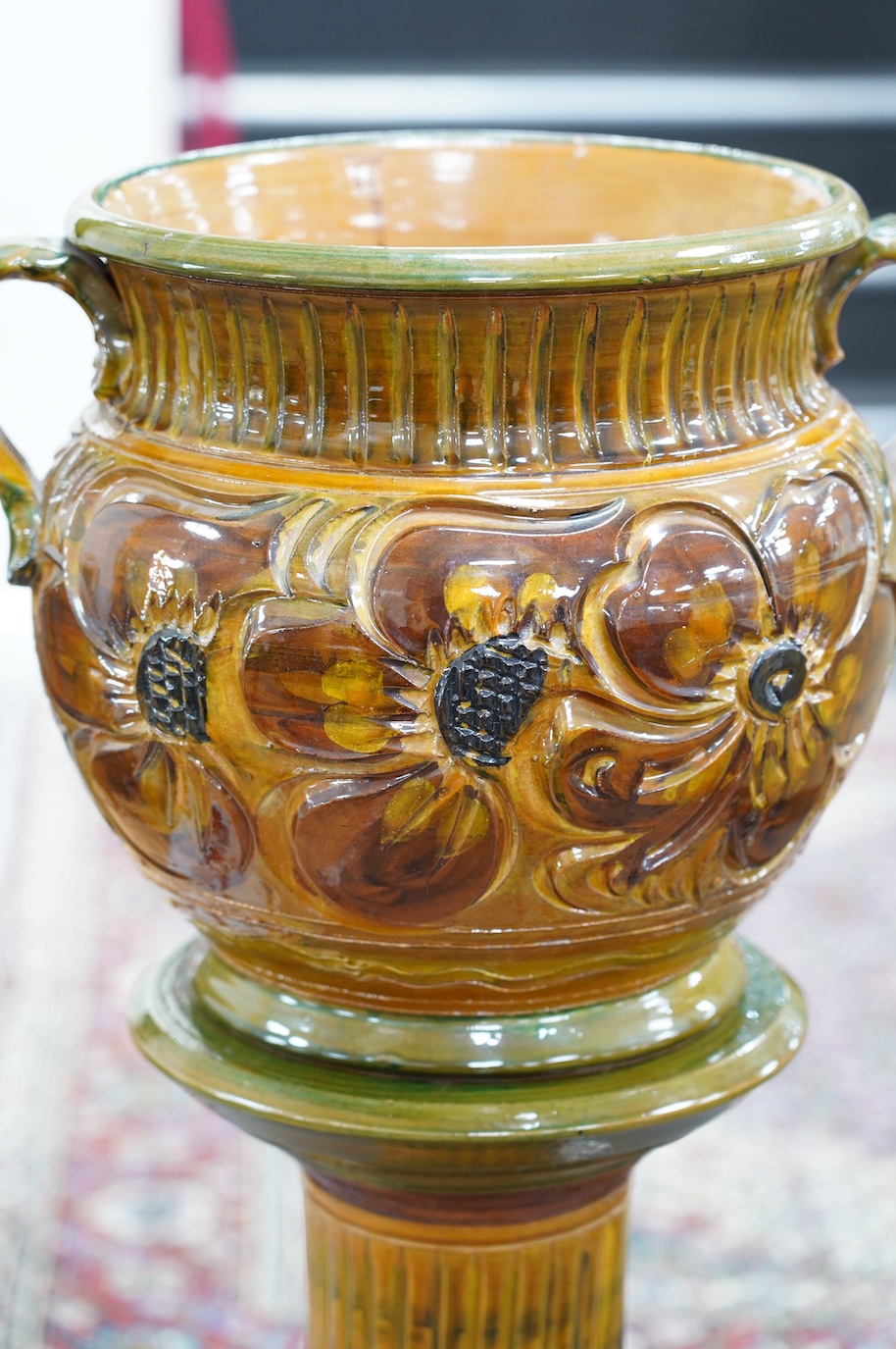 A terracotta jardiniere on stand with incised stylised floral decoration, 102cm high. Condition - good